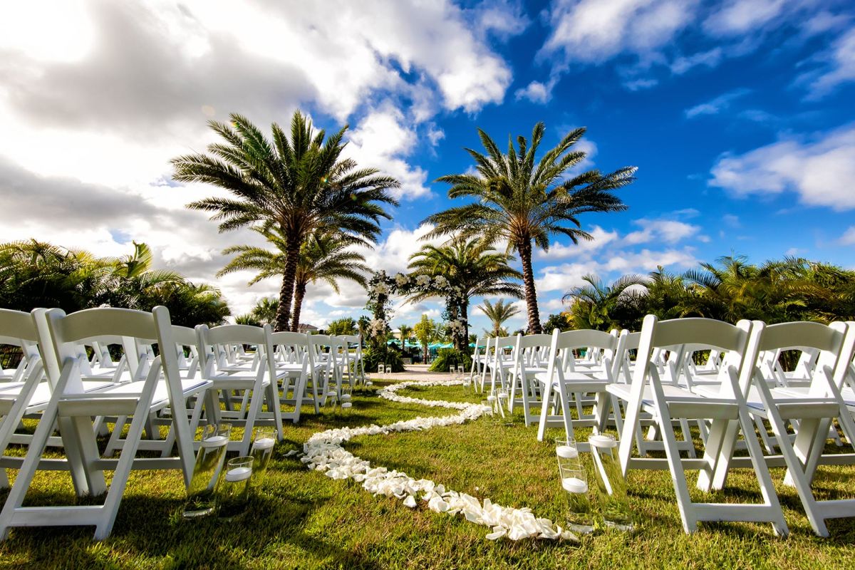 Chairs and flower petals set up on the Margaritaville Resort Orlando event lawn.