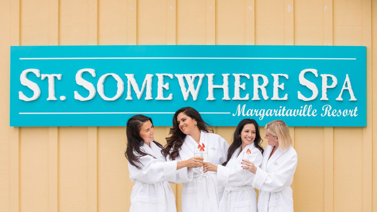 Group of women in bath robes posing together outside St. Somewhere Spa.