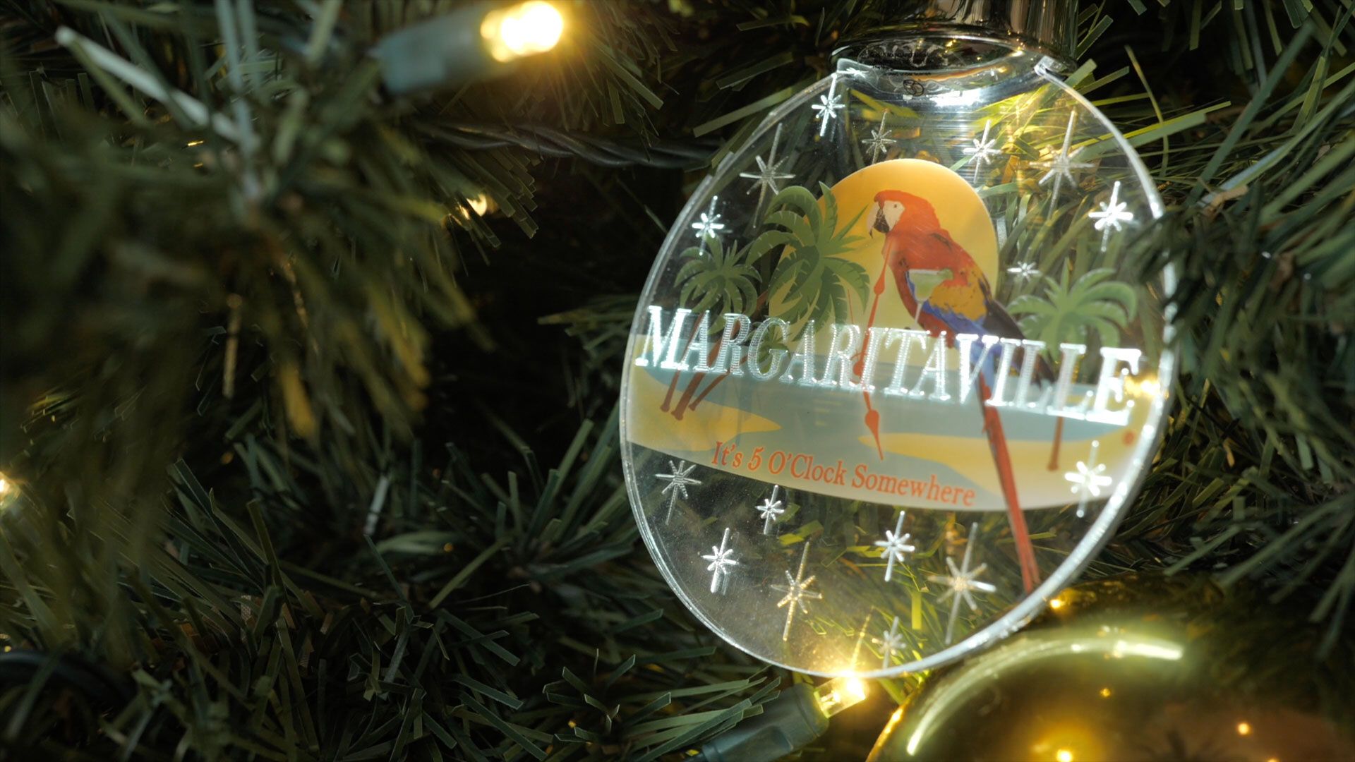 Margaritaville ornament on a lit Christmas tree.