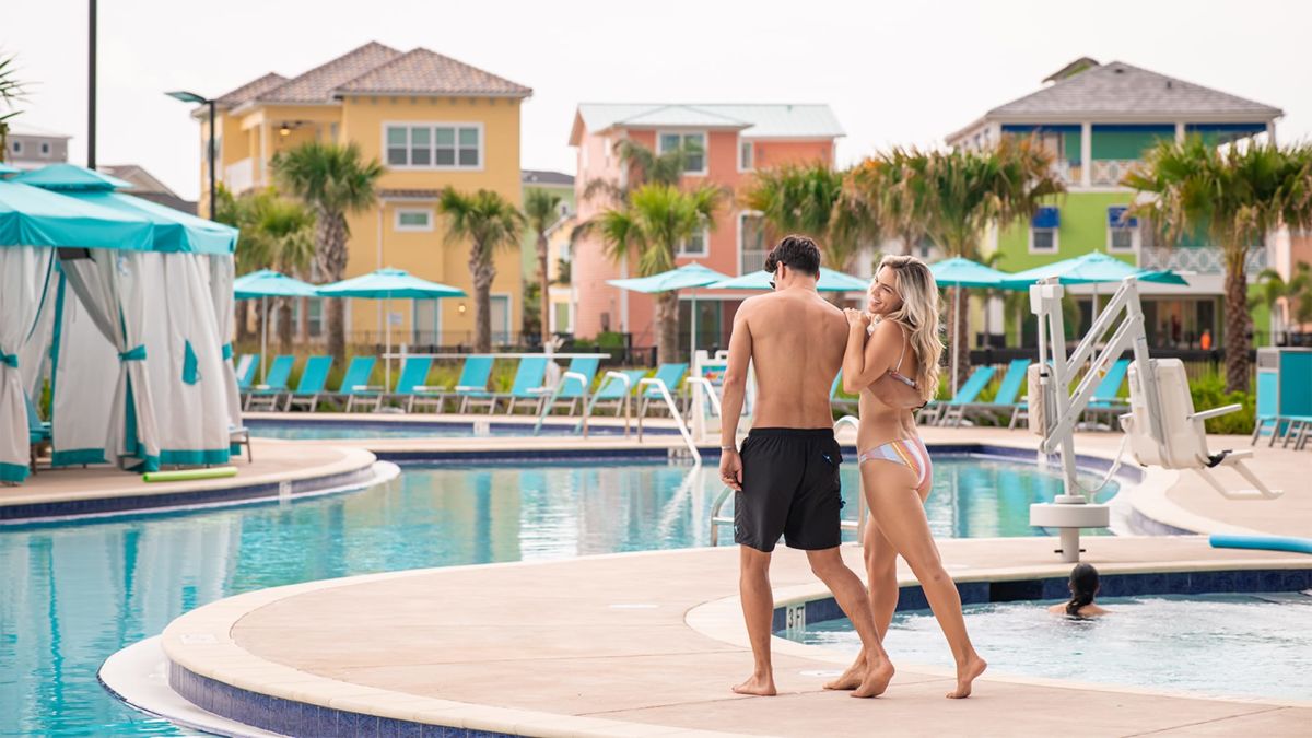 Couple walking together by the pool at Margaritaville Resort Orlando.