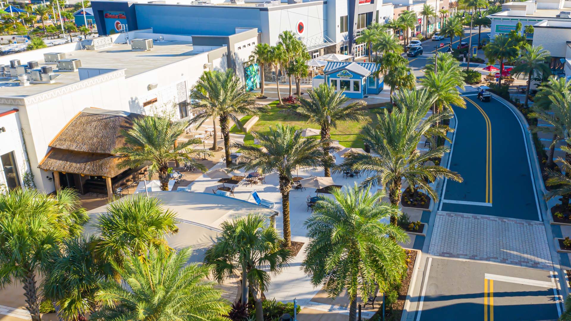 Aerial view of the Promenade Plaza Stage surrounded by Palm trees and storefronts.