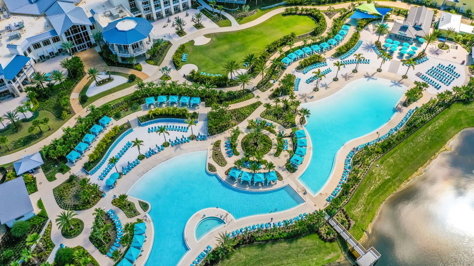 Aerial view of the Margaritaville Resort Orlando hotel, pools, and Fins Up Beach Club area.