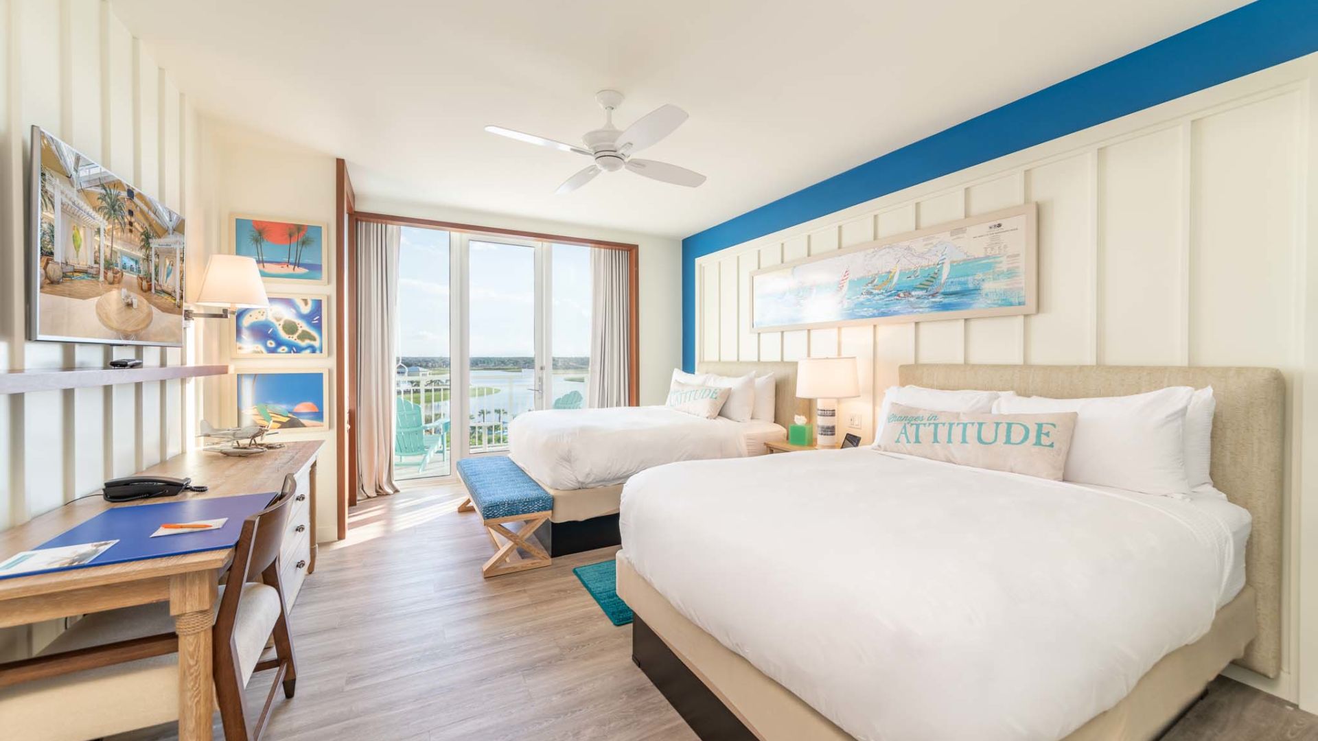Two queen beds and door to a balcony in an accessible Margaritaville Resort Orlando hotel room.