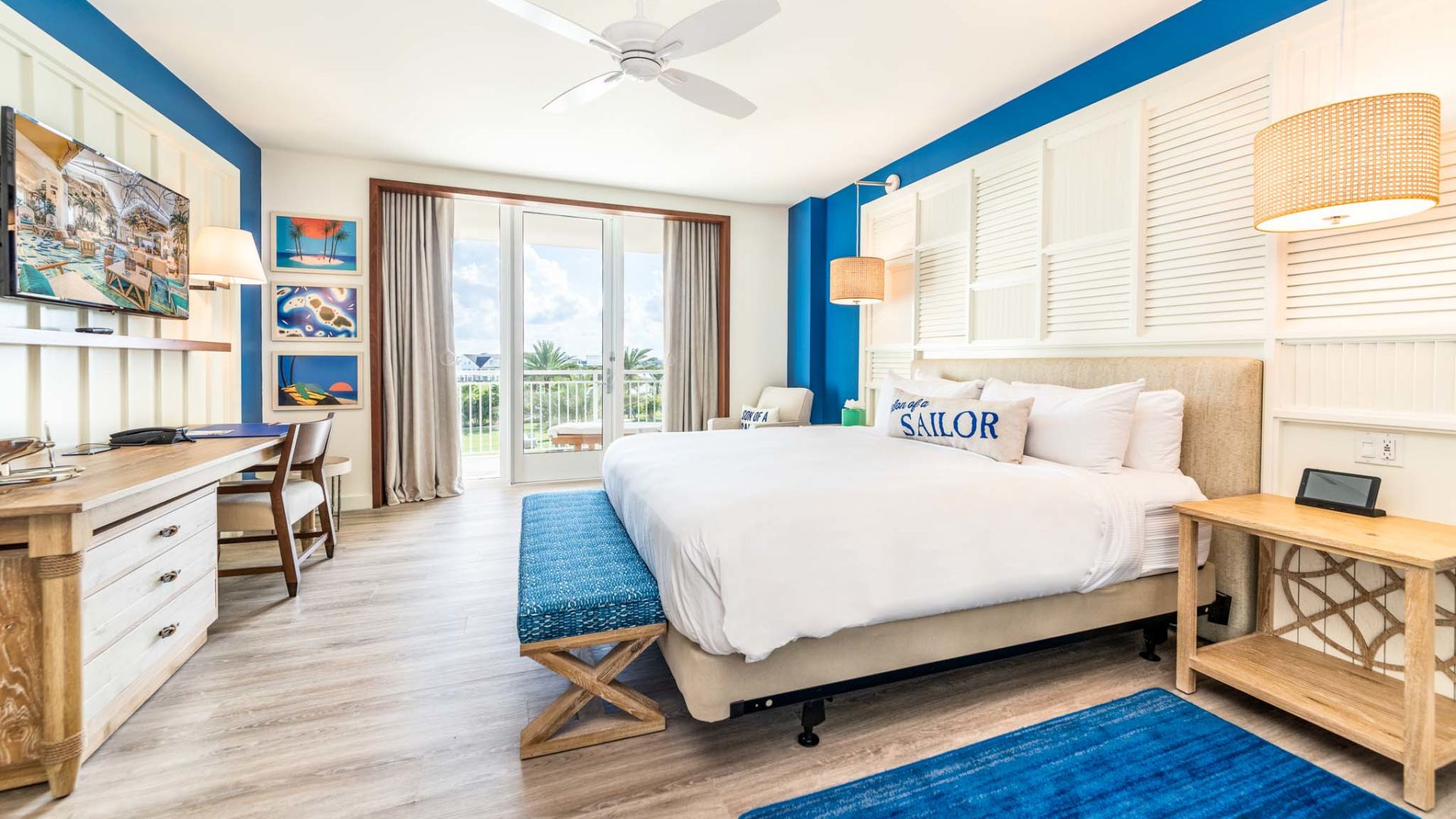 Large king bed and balcony access in an accessible Margaritaville Resort Orlando suite.