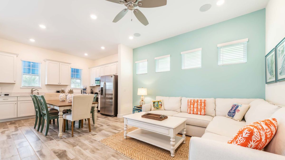 Furnished living room and kitchen of a Margaritaville Resort Orlando cottage.