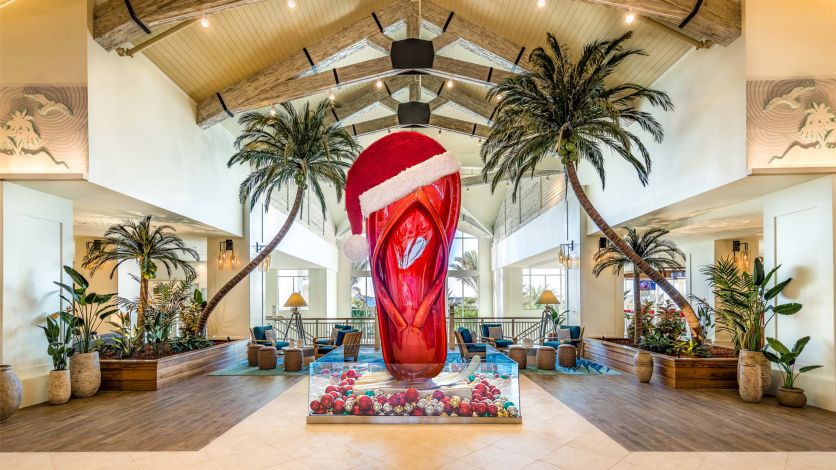 Santa Claus hat on top of Margaritaville Resort Orlando’s giant flip flop sculpture.