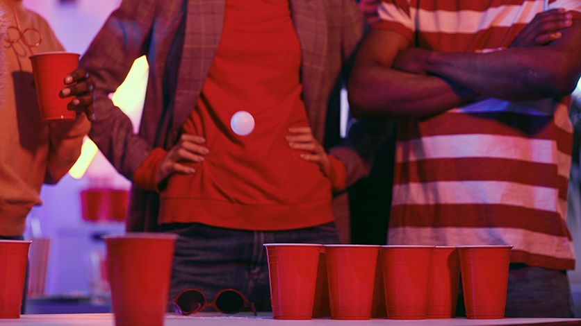 Observers watching a beer pong game