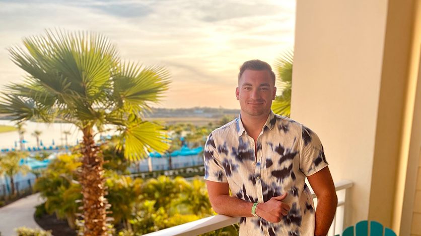 Man posing for a photo on a balcony at Margaritaville Resort Orlando
