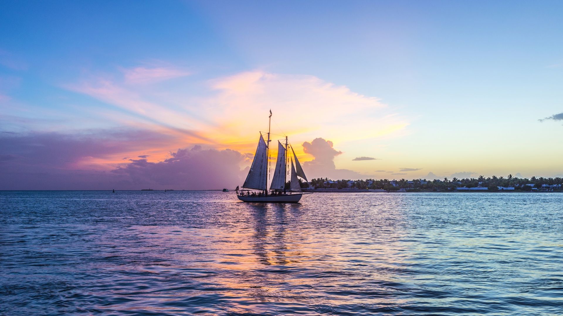 A Sailboat on the water at sunset