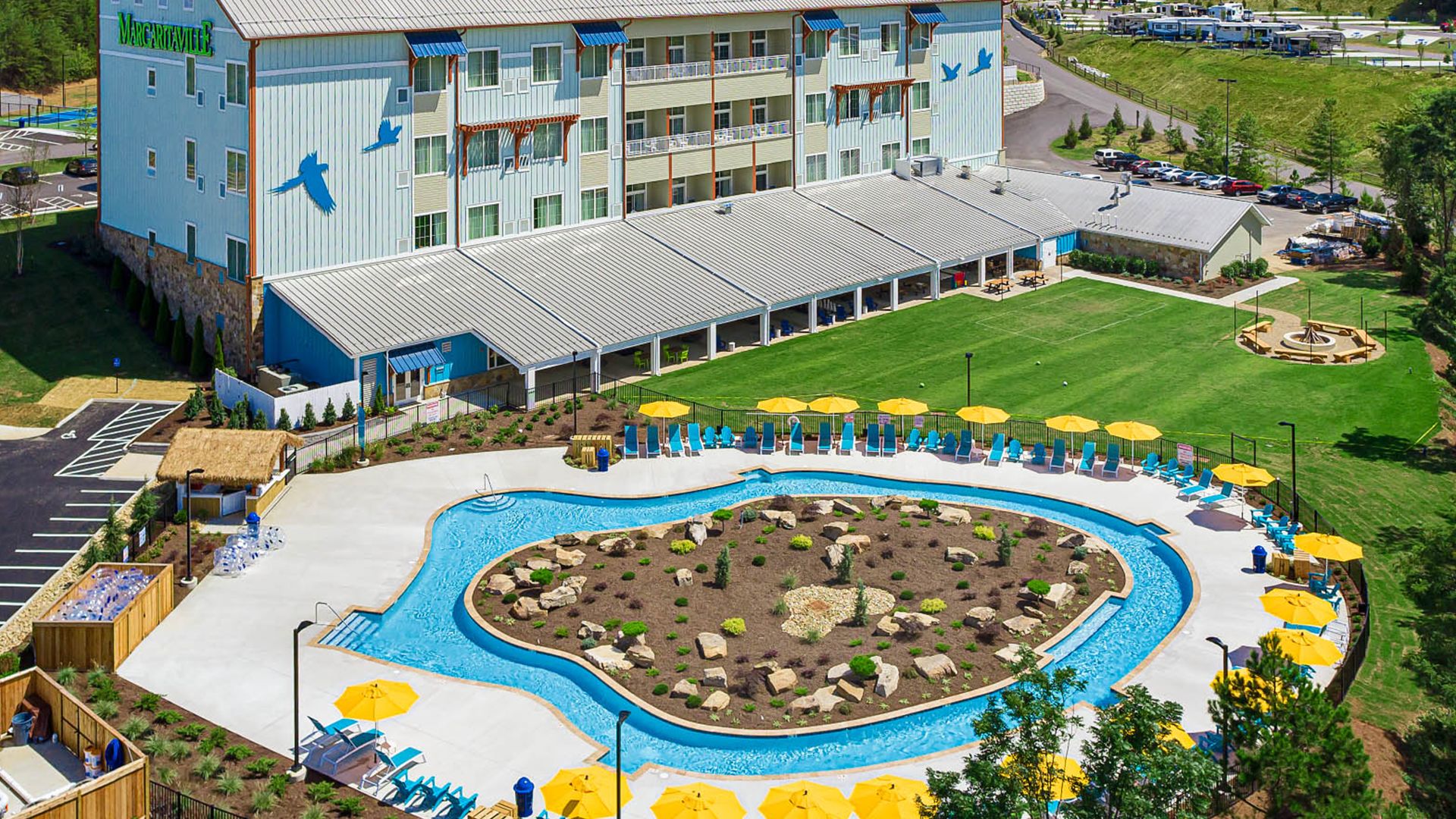 A Large Building With A Pool In Front Of It