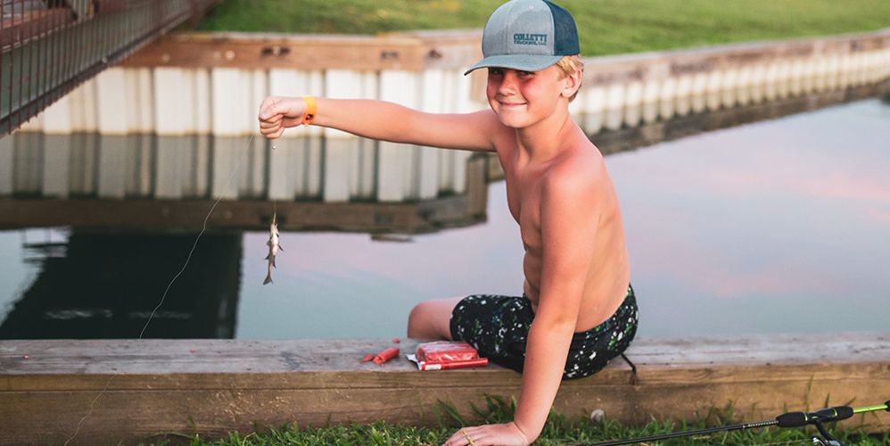A Boy Fishing On A Dock