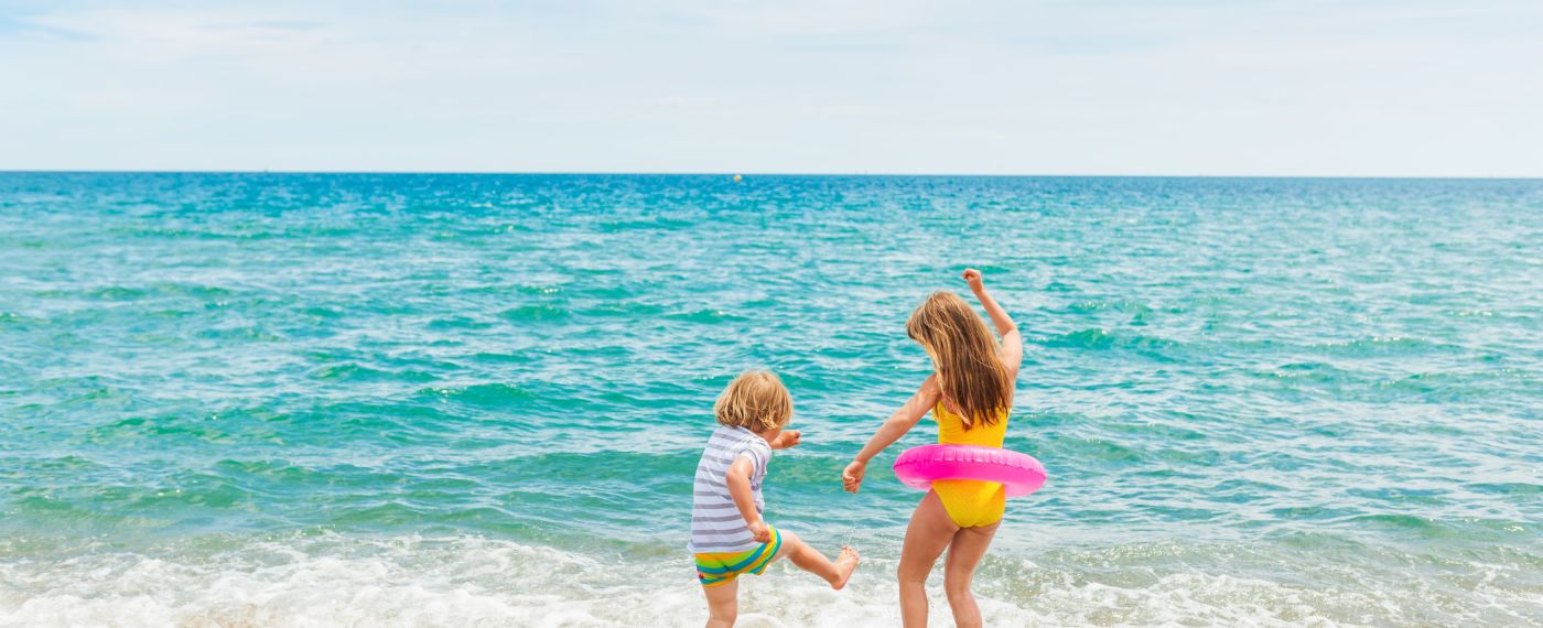 Two Children Playing On The Beach
