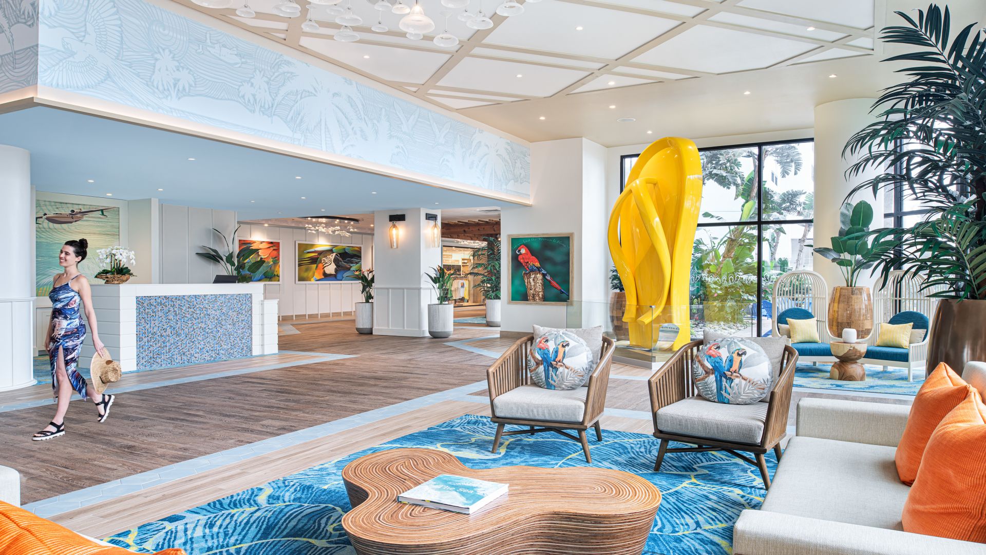 Lobby of Resort with couches and chairs and colorful rug and yellow flip flop sculpture