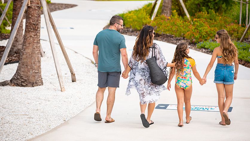 A family holding hands while walking