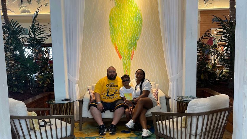 Family taking a photo in the Margaritaville Resort Orlando lobby