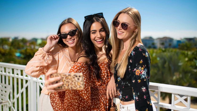Women taking a selfie on their Margaritaville Resort Orlando balcony