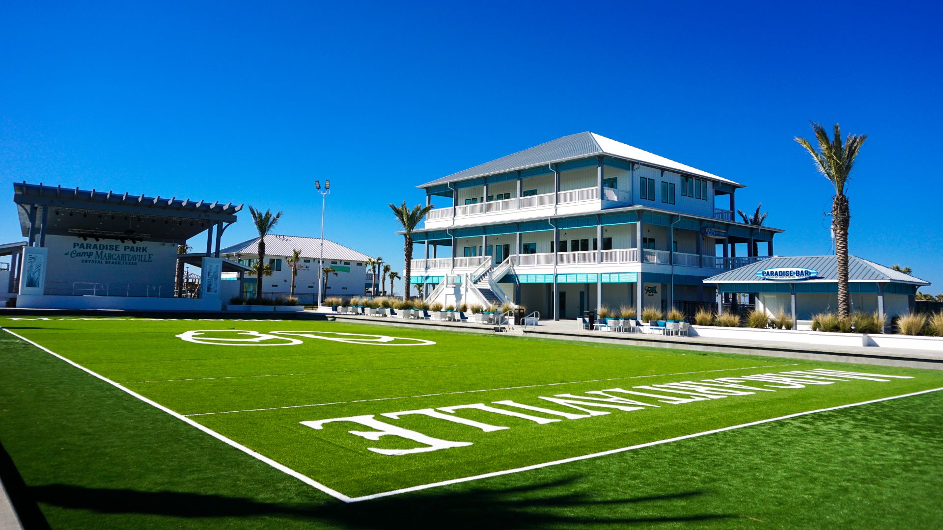 A Football Field With A Building In The Background