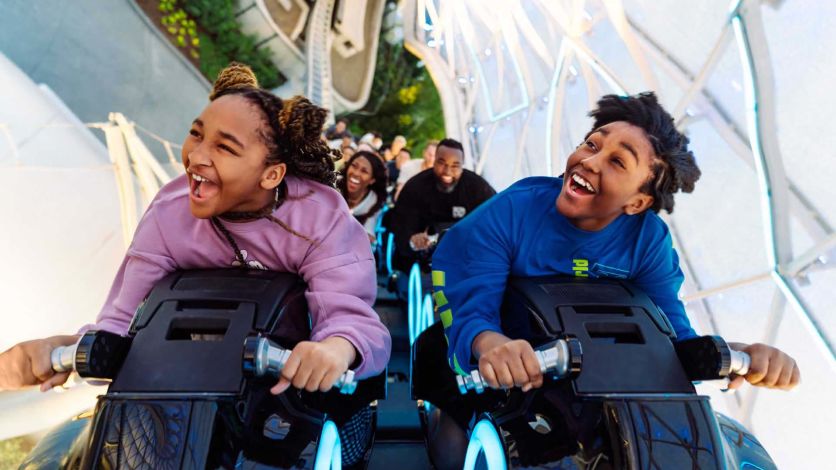 Siblings riding the Tron roller coaster at the Magic Kingdom
