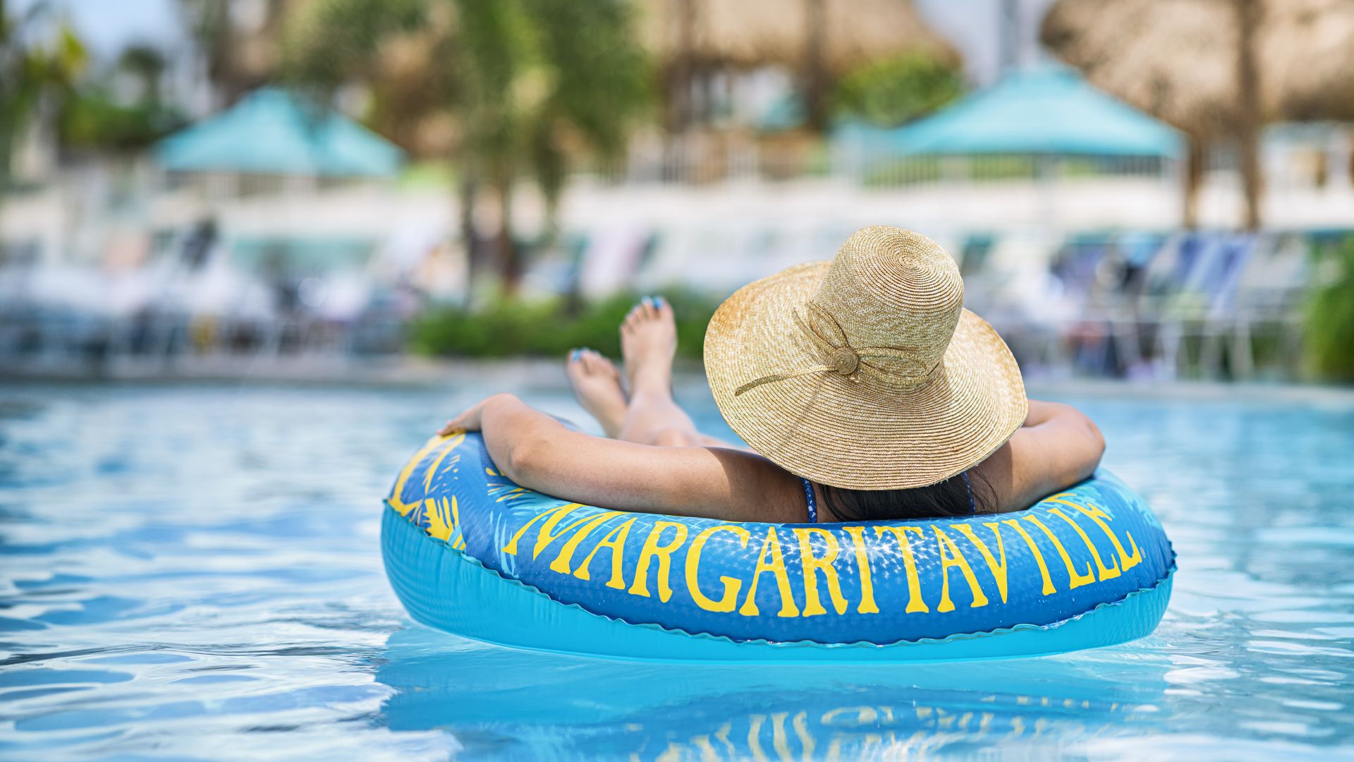 A Person In A Straw Hat In A Pool
