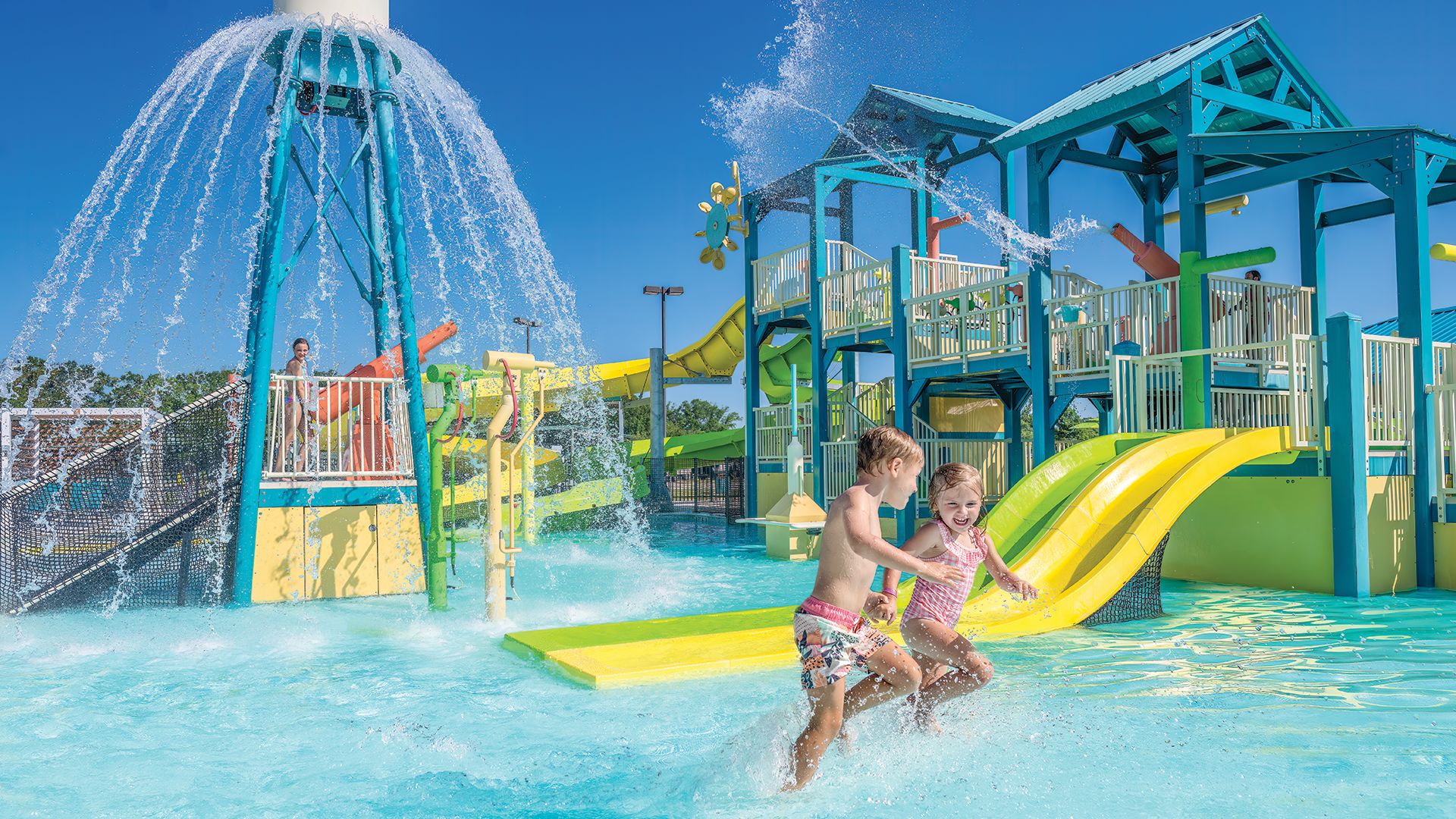 A Person And A Child In A Water Park