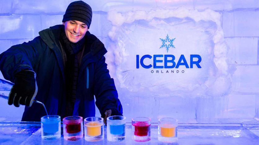 A bartender pouring cocktails at ICEBAR Orlando