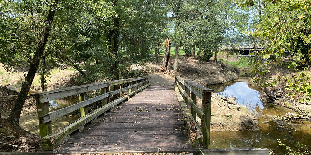 A Wooden Bridge Over A River