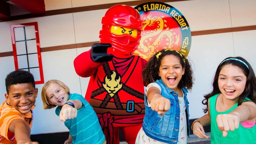 Group of children posing for a photo with a LEGO Ninja at LEGOLAND