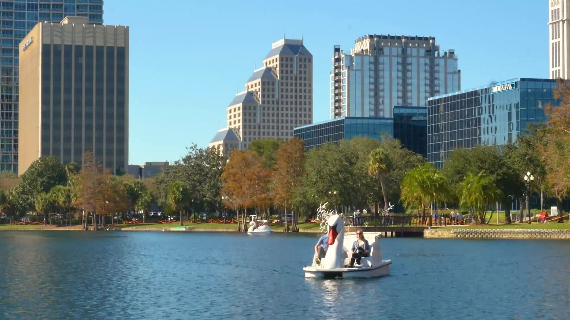 People riding a swan boat on Lake Eola in downtown Orlando