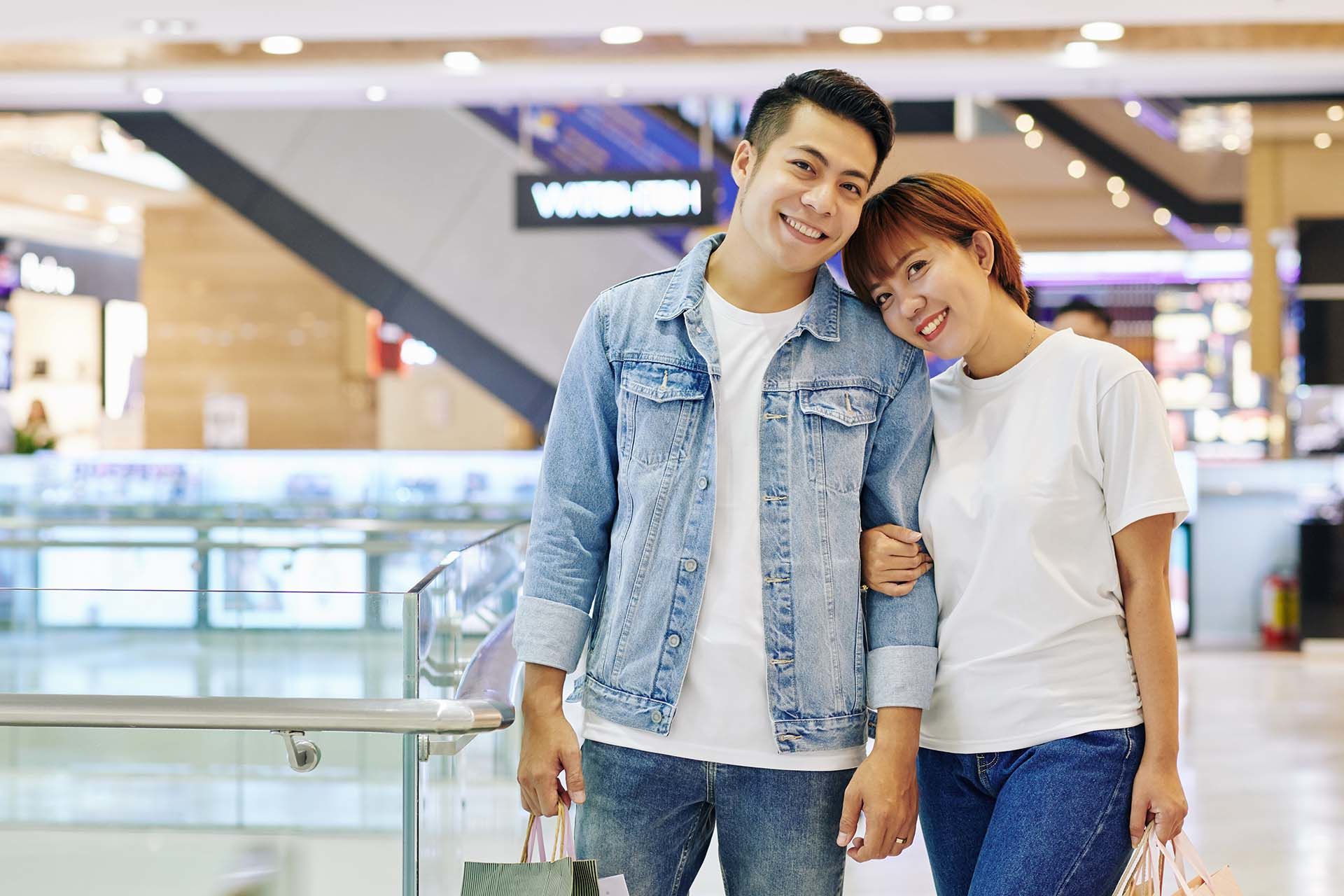 Happy couple standing together in a shopping mall